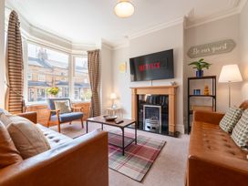 A living room with a sofa and television at 18 Mayville Avenue Scarborough