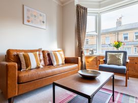 A living room with a sofa and armchair at 18 Mayville Avenue, Scarborough