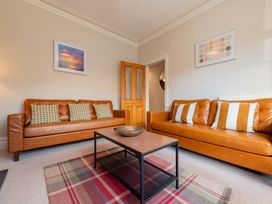 A living room with sofas and a coffee table at 18 Mayville Avenue Scarborough