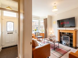 A living room with a sofa and TV at 18 Mayville Avenue in Scarborough
