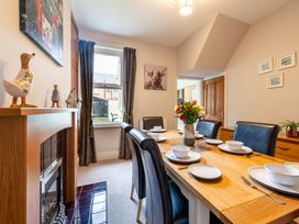 A dining room with a table set for meals at 18 Mayville Avenue in Scarborough