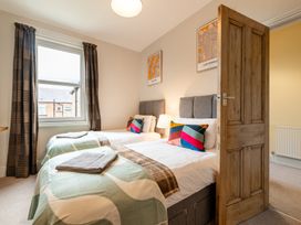 A bedroom with two beds and a window at 18 Mayville Avenue Scarborough