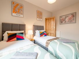 Two single beds with colorful pillows in a bedroom at 18 Mayville Avenue Scarborough