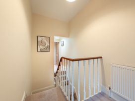 A hallway with a staircase and artwork on the wall at 18 Mayville Avenue, Scarborough