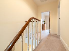 A hallway with a staircase and chest of drawers at 18 Mayville Avenue Scarborough