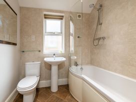 A bathroom with a toilet, sink and shower at 18 Mayville Avenue Scarborough