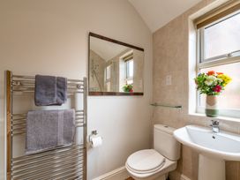 A bathroom with a towel warmer and a mirror at 18 Mayville Avenue Scarborough