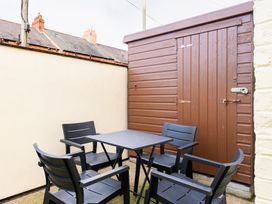 A garden with a table and chairs next to a shed at 18 Mayville Avenue Scarborough