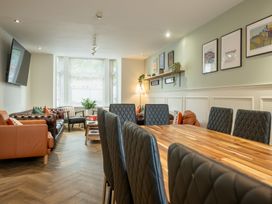 A dining room with a table and chairs and a sofa area at 125 Columbus Ravine in Scarborough