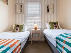 A bedroom with two beds and a lamp on a nightstand at 125 Columbus Ravine in Scarborough