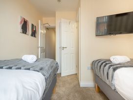 A bedroom with two beds and a television at 125 Columbus Ravine in Scarborough