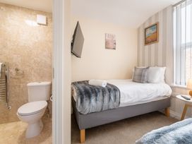 A bedroom with a bed and a bathroom including a toilet at 125 Columbus Ravine, Scarborough