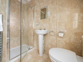 A bathroom with a shower, sink, and toilet at 125 Columbus Ravine in Scarborough