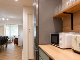 A kitchen with a refrigerator, microwave, and toaster at 125 Columbus Ravine in Scarborough