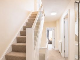 A hallway with stairs, a mirror, and doors at 125 Columbus Ravine Scarborough