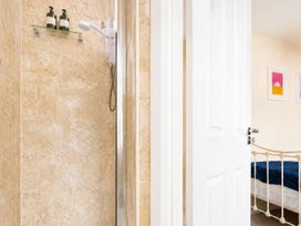 A shower with soap dispenser and a door leading to a bedroom at 125 Columbus Ravine in Scarborough
