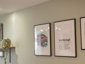 A living room with framed pictures and a shelf at 125 Columbus Ravine, Scarborough