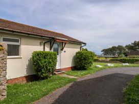 A house with bushes and pathway at Cottage 28 in Brixham