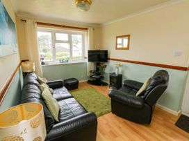 A living room with a sofa and television at Cottage 28 in Brixham