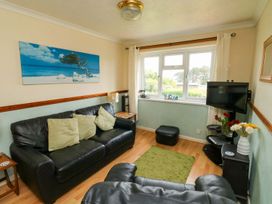 A living room with a sofa and television at Cottage 28 in Brixham