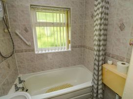 A bathroom featuring a bathtub and a toilet at Cottage 28 in Brixham