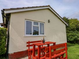 An outdoor seating area with a table and chairs at Cottage 28 in Brixham