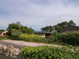 A view of a road with greenery and buildings at Cottage 28 in Brixham