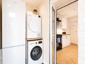 A laundry room with appliances and kitchen access at 127 Columbus Ravine Scarborough