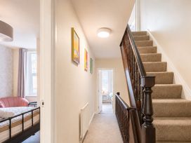 A hallway with a staircase and a bed in a room at 127 Columbus Ravine Scarborough