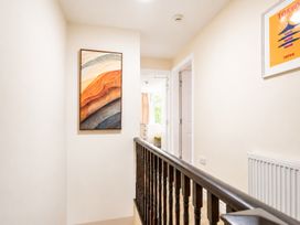 A hallway with a staircase and painting at 127 Columbus Ravine in Scarborough