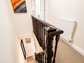 A staircase with a banister and radiator in a hallway at 127 Columbus Ravine, Scarborough