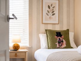 A bedroom with a dog pillow and lamp at 127 Columbus Ravine, Scarborough