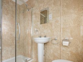 A bathroom with a shower, sink, and toilet at 127 Columbus Ravine, Scarborough