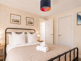 A bedroom with a bed and artwork on walls at 127 Columbus Ravine in Scarborough