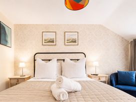 A bedroom with a bed, side tables, and art on the wall at 127 Columbus Ravine, Scarborough