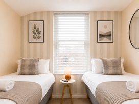 A bedroom with two beds and a side table at 127 Columbus Ravine, Scarborough