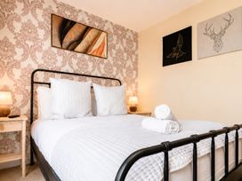 A bedroom with a bed and wall art at 127 Columbus Ravine, Scarborough
