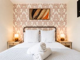 A bedroom with a bed and bedside tables at 127 Columbus Ravine in Scarborough