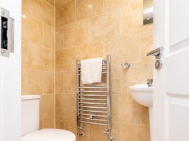 A bathroom with a toilet, sink, and towel rail at 127 Columbus Ravine Scarborough