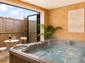 A hot tub with a table and chairs at 127 Columbus Ravine Scarborough