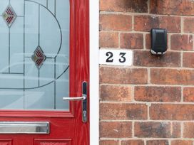 A red door with a mailbox and house number 23 at 23 Trafalgar Road Scarborough