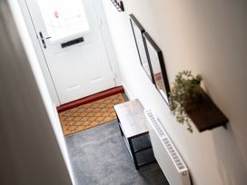 A hallway with a front door and a console table at 23 Trafalgar Road Scarborough