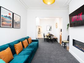 A living room with a sofa and dining table at 23 Trafalgar Road in Scarborough