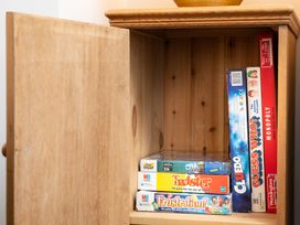 A game cabinet with various board games at 23 Trafalgar Road, Scarborough