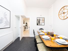 A dining room with a table set for breakfast at 23 Trafalgar Road Scarborough