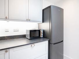 A kitchen with a microwave and refrigerator at 23 Trafalgar Road Scarborough