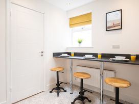 A kitchen with bar stools and a table at 23 Trafalgar Road in Scarborough