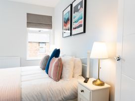A bedroom with a bed and pillows at 23 Trafalgar Road Scarborough