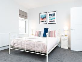 A bedroom with a bed and artwork on the wall at 23 Trafalgar Road in Scarborough