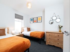 A bedroom with two beds and artwork on the wall at 23 Trafalgar Road in Scarborough